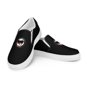 Step into activism with our Antifascist Action Men’s Slip-on Canvas Shoes. These sleek black shoes feature the iconic Antifa design, making a bold statement wherever you go. With elastic side accents for easy wear, a breathable lining keeps your feet comfortable all day long. The soft insole adds extra cushioning.