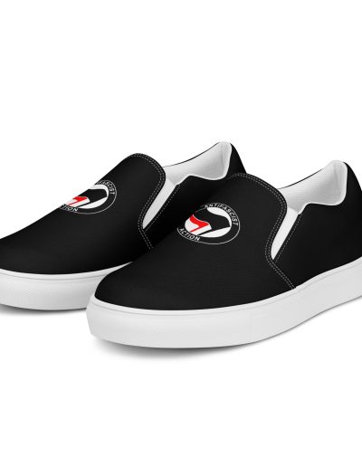 Step into activism with our Antifascist Action Men’s Slip-on Canvas Shoes. These sleek black shoes feature the iconic Antifa design, making a bold statement wherever you go. With elastic side accents for easy wear, a breathable lining keeps your feet comfortable all day long. The soft insole adds extra cushioning.