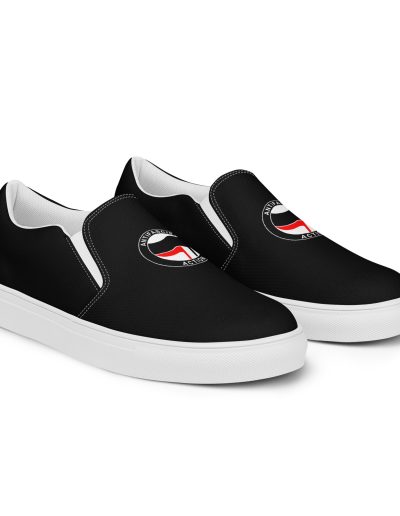 Step into activism with our Antifascist Action Men’s Slip-on Canvas Shoes. These sleek black shoes feature the iconic Antifa design, making a bold statement wherever you go. With elastic side accents for easy wear, a breathable lining keeps your feet comfortable all day long. The soft insole adds extra cushioning.