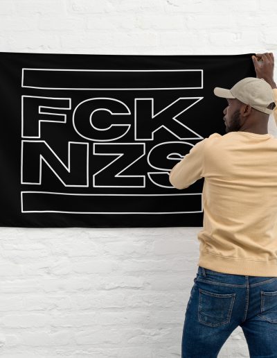 The FCK NZS Outline Flag is a bold statement piece for any space. Made from 100% durable polyester, this flag features two sturdy iron grommets for easy hanging. The minimalist FCK NZS outline design stands out, delivering a powerful anti-fascist message. Perfect for indoor or outdoor display, this flag is built to withstand the elements while showing your support for the cause. Whether at home, at rallies, or at events, make your stance clear with this eye-catching flag.